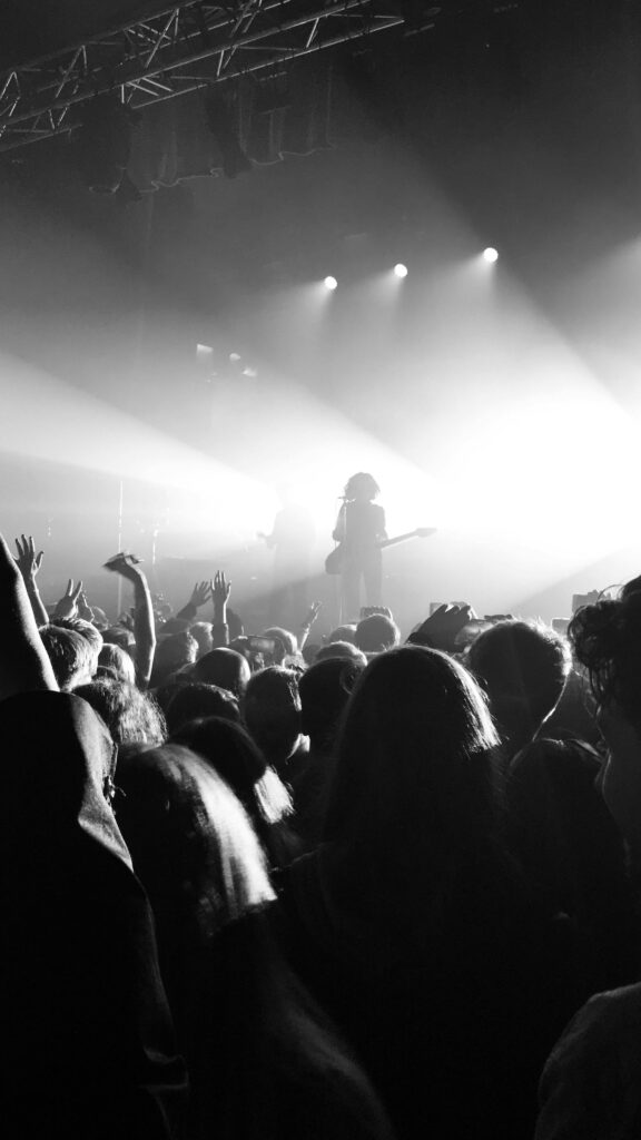 Captivating grayscale image of a lively concert crowd in Manchester.